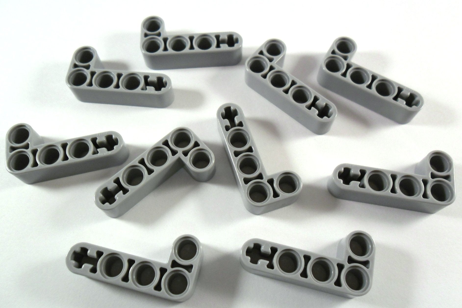 10 pieces LEGO TECHNIC "Liftarm 2x4 knobs L-shape" in new light gray. - 32140