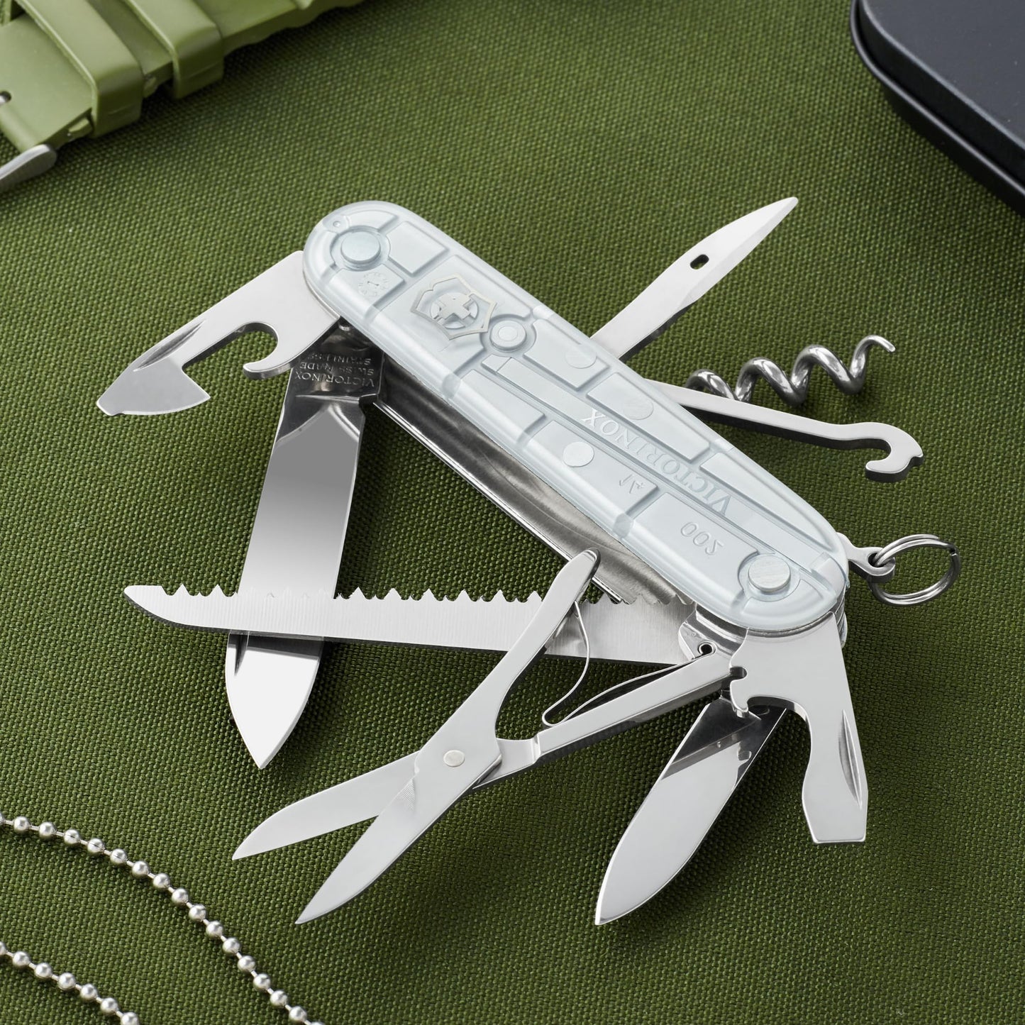 Victorinox Swiss pocket knife Huntsman, multitool, Swiss Army knife with 15 functions, blade, corkscrew, can opener, folding box, silver transparent - 1.3713.T7